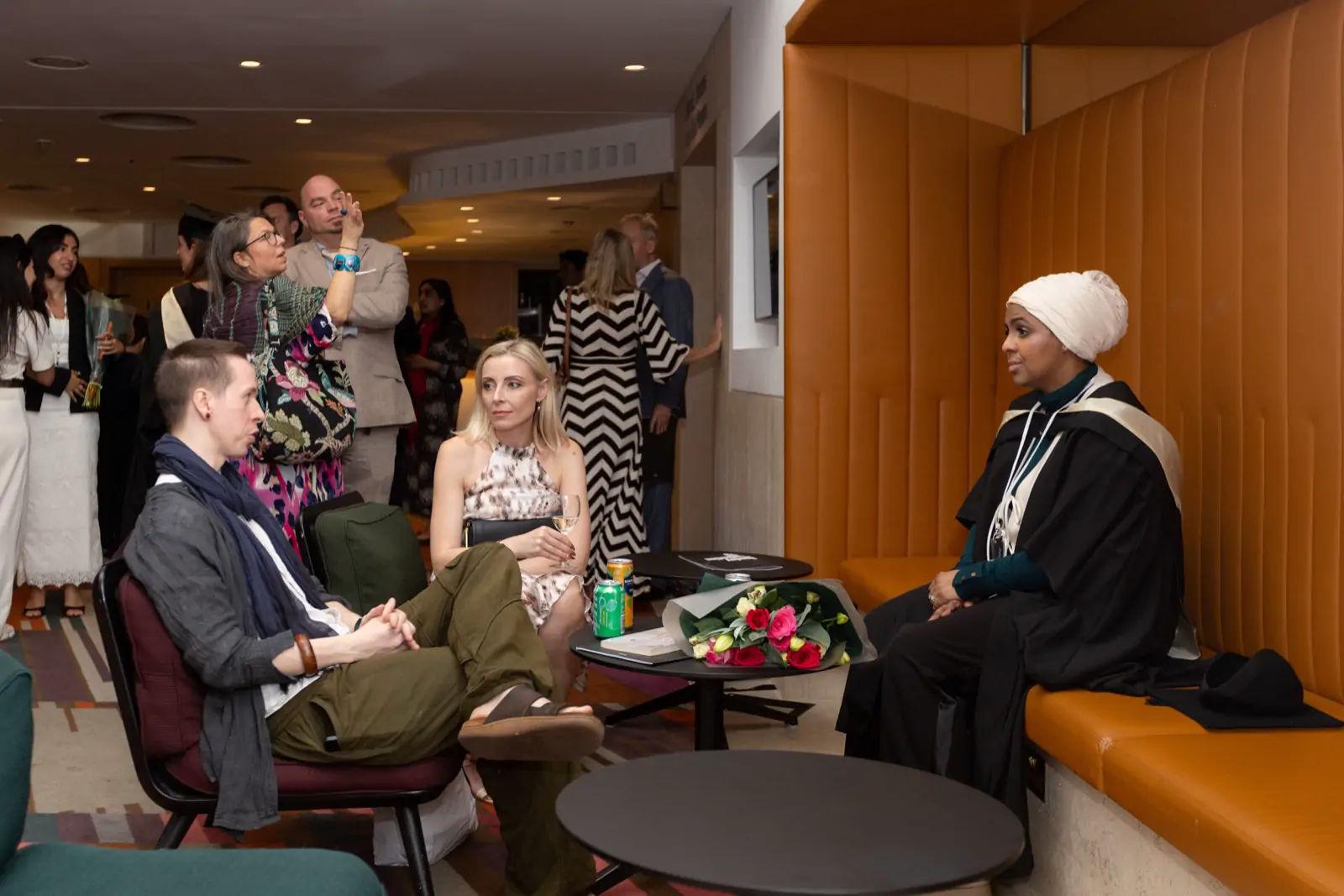 The graduation reception, with Ines Abdalla seated at the far end of the room